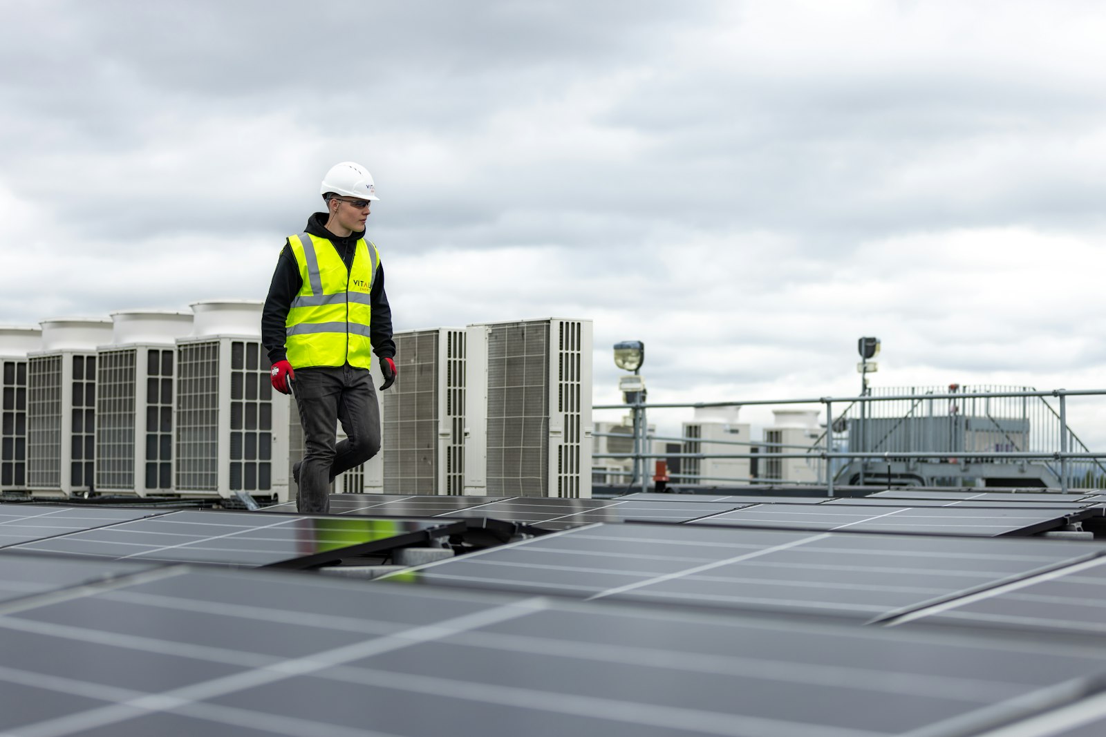 Technician on a commercial roof with mechanical equipment