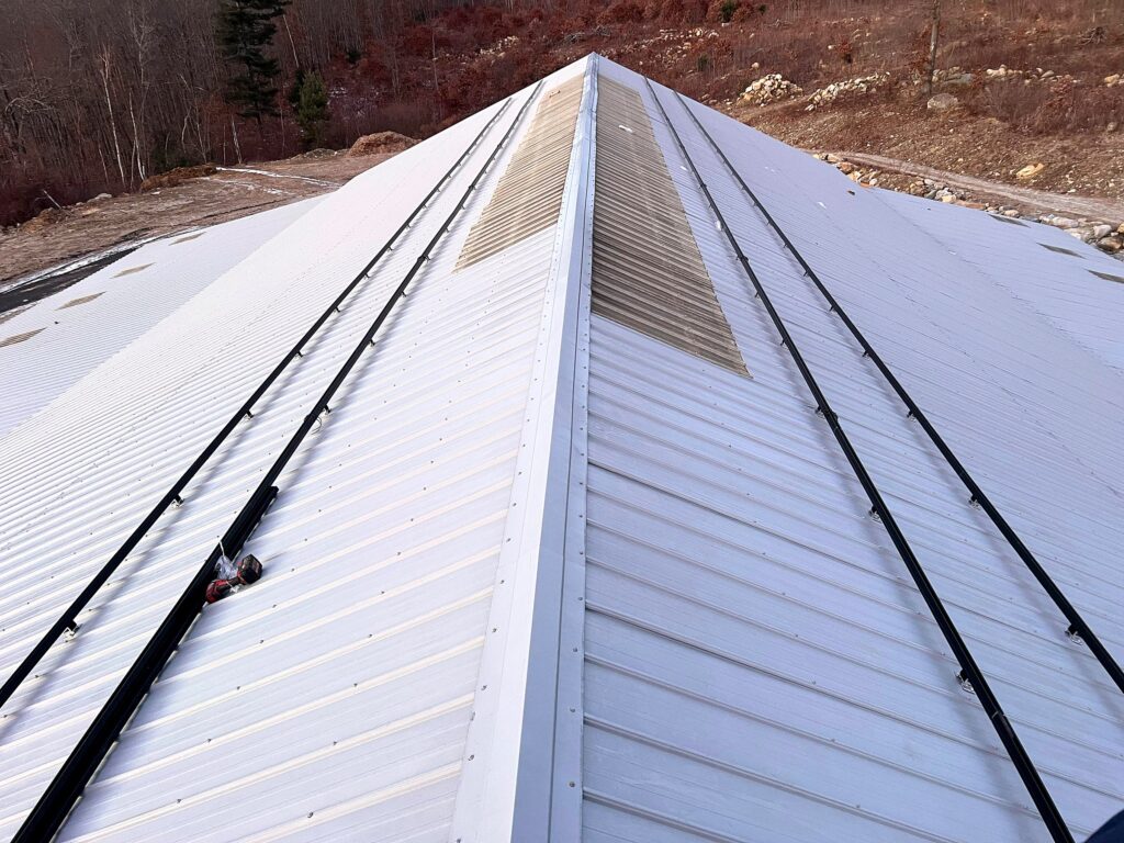 Solar racking rails installed on both sides of a metal roof
