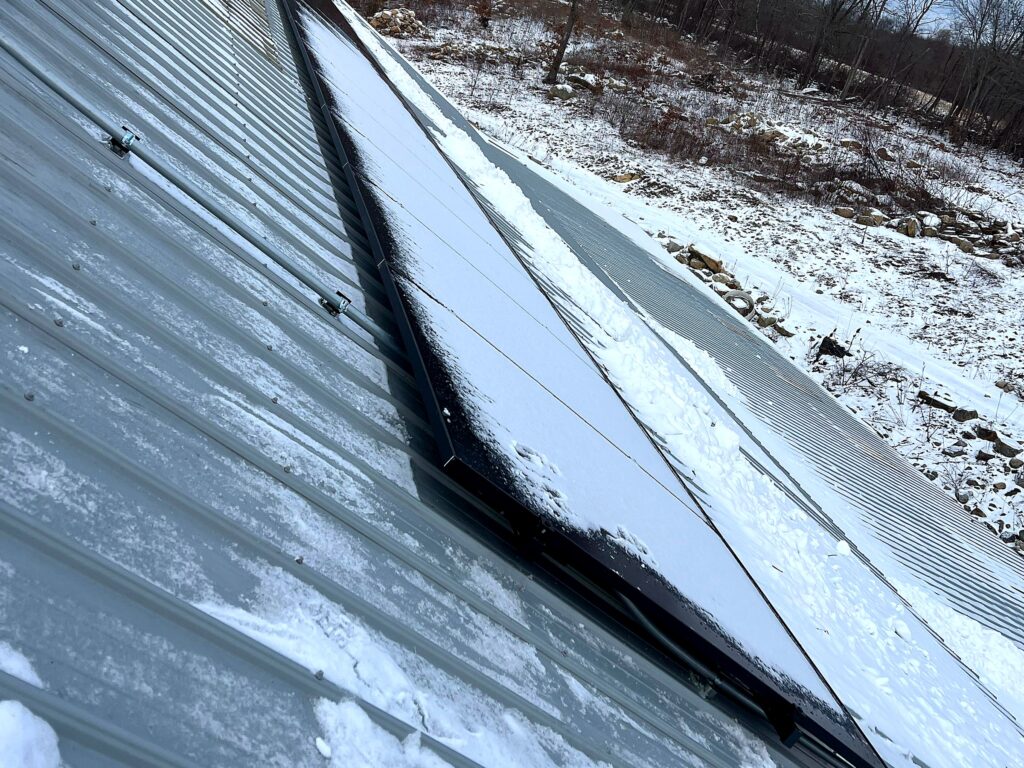 Rooftop conduit run from the solar array on a metal roof