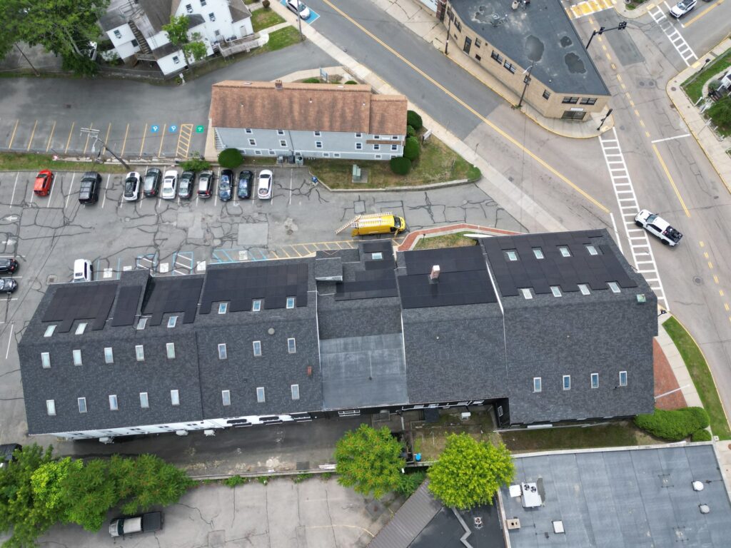 Overhead drone view of Fazza Commons solar arrays with the Alexa service van