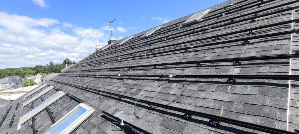 Solar racking and wiring installed on the Fazza Commons roof before panel placement