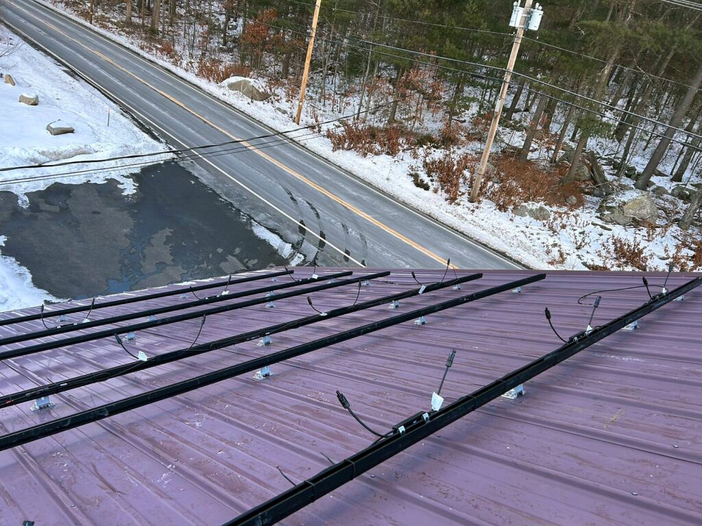 Solar racking rails with module-level wiring on the roof overlooking Mammoth Road