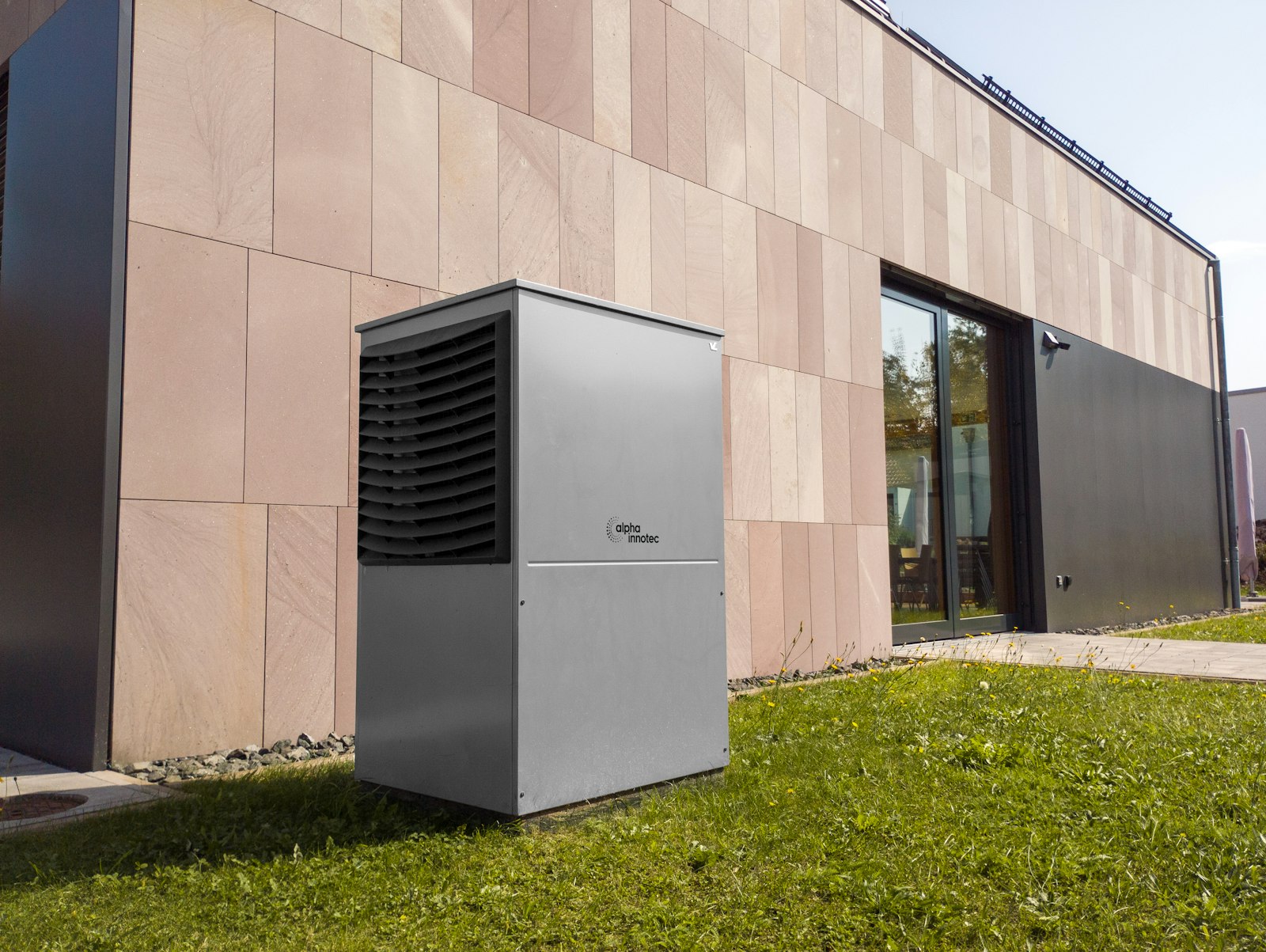 Heat pump outdoor unit beside a modern home