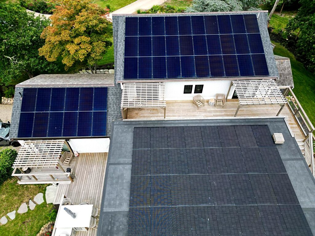 Close drone view of residential rooftop solar arrays in Brewster, MA
