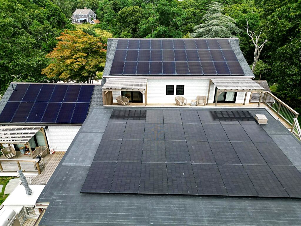 Solar arrays on the pitched and flat roofs of a home in Brewster, MA