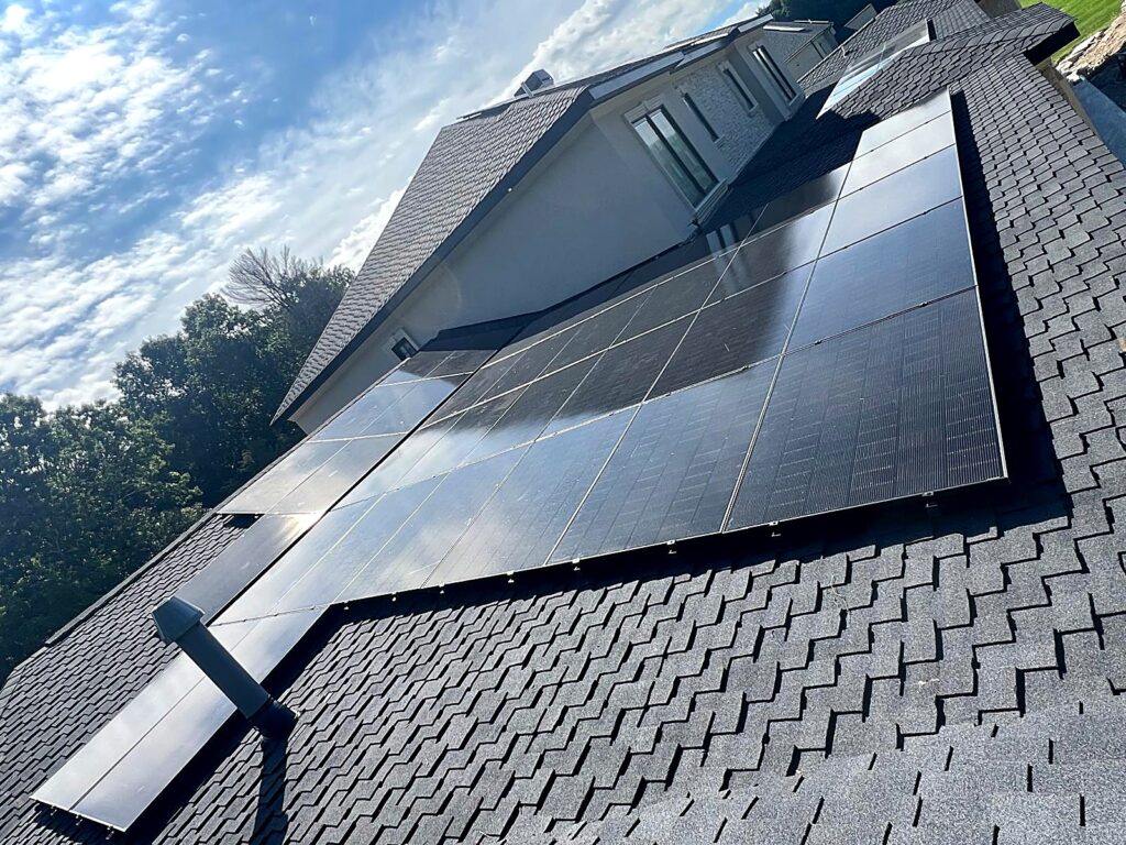 Residential rooftop solar array under a blue sky