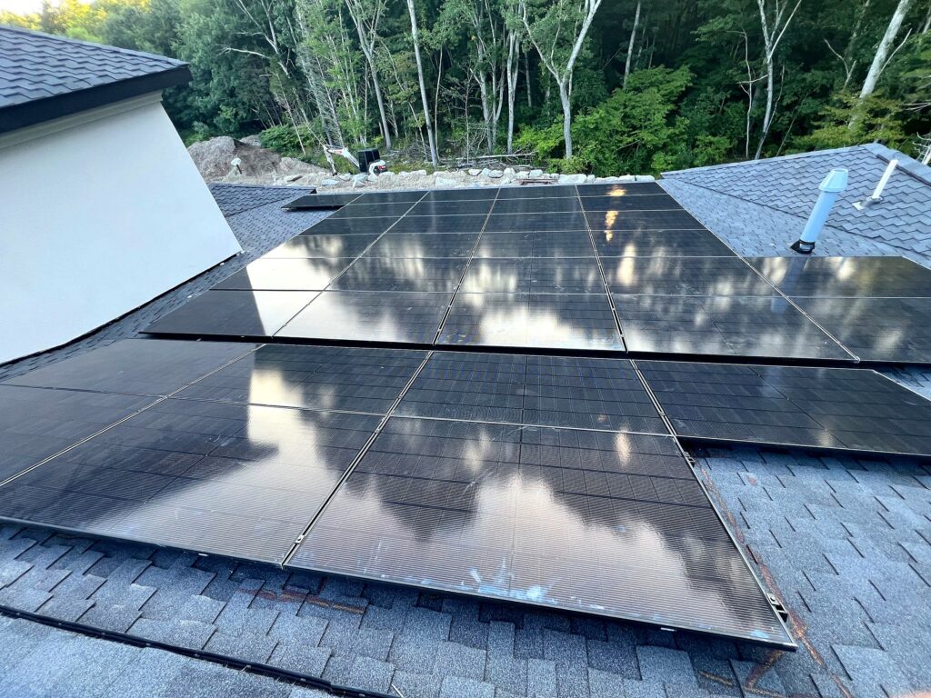 Residential solar array reflecting the surrounding trees