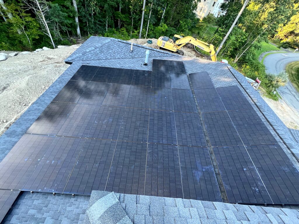 Overhead view of a large residential rooftop solar array in Massachusetts