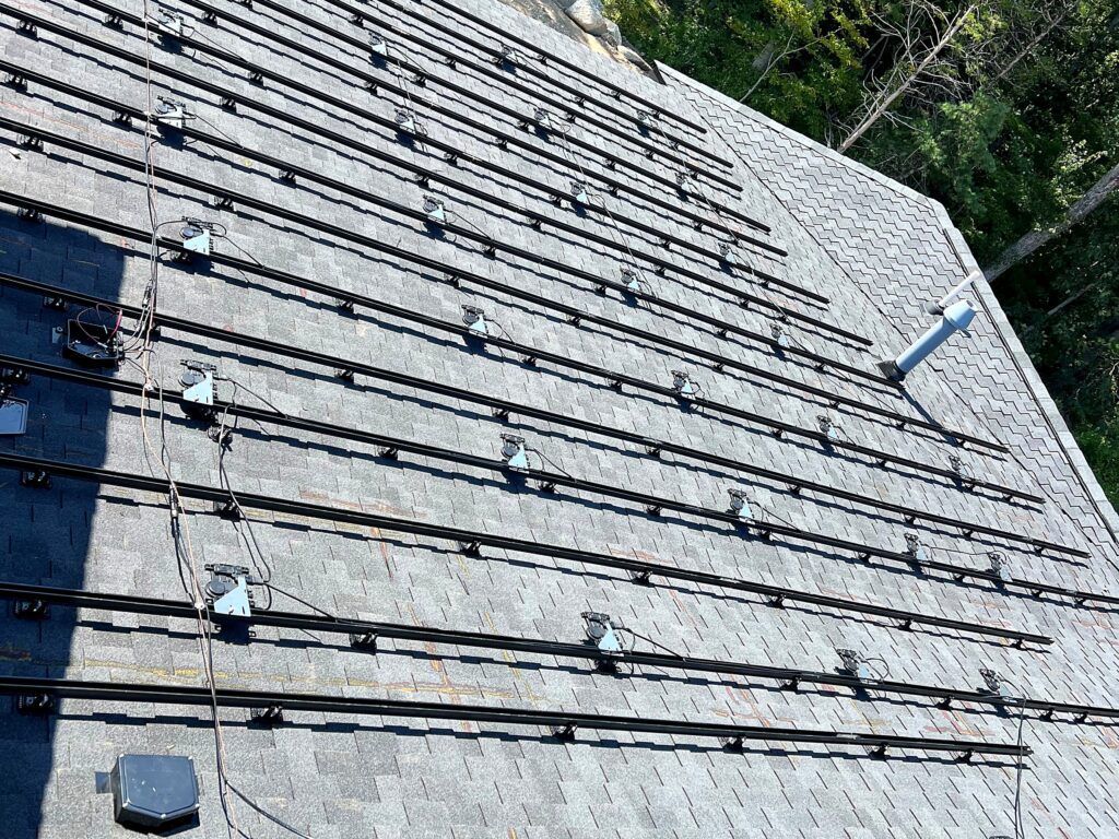 Solar racking rails with Enphase microinverters installed before the panels