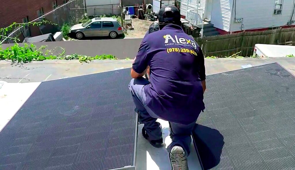 Alexa Energy Power Solutions installer working between solar modules on the flat roof