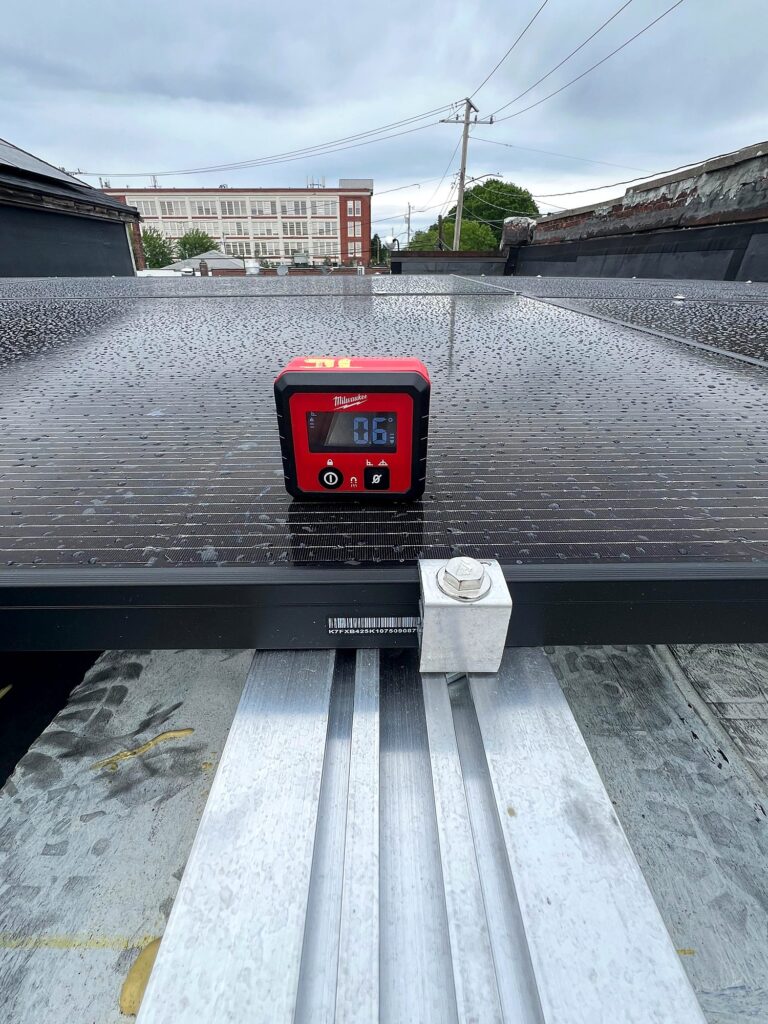 Digital level check on a solar module during installation
